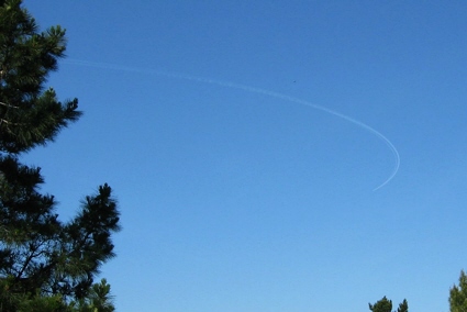 An L-1011 jet carrying a Pegasus rocket and DART satellite heads for the launch point