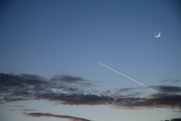 Delta IV rocket trail passes below the Moon and Venus